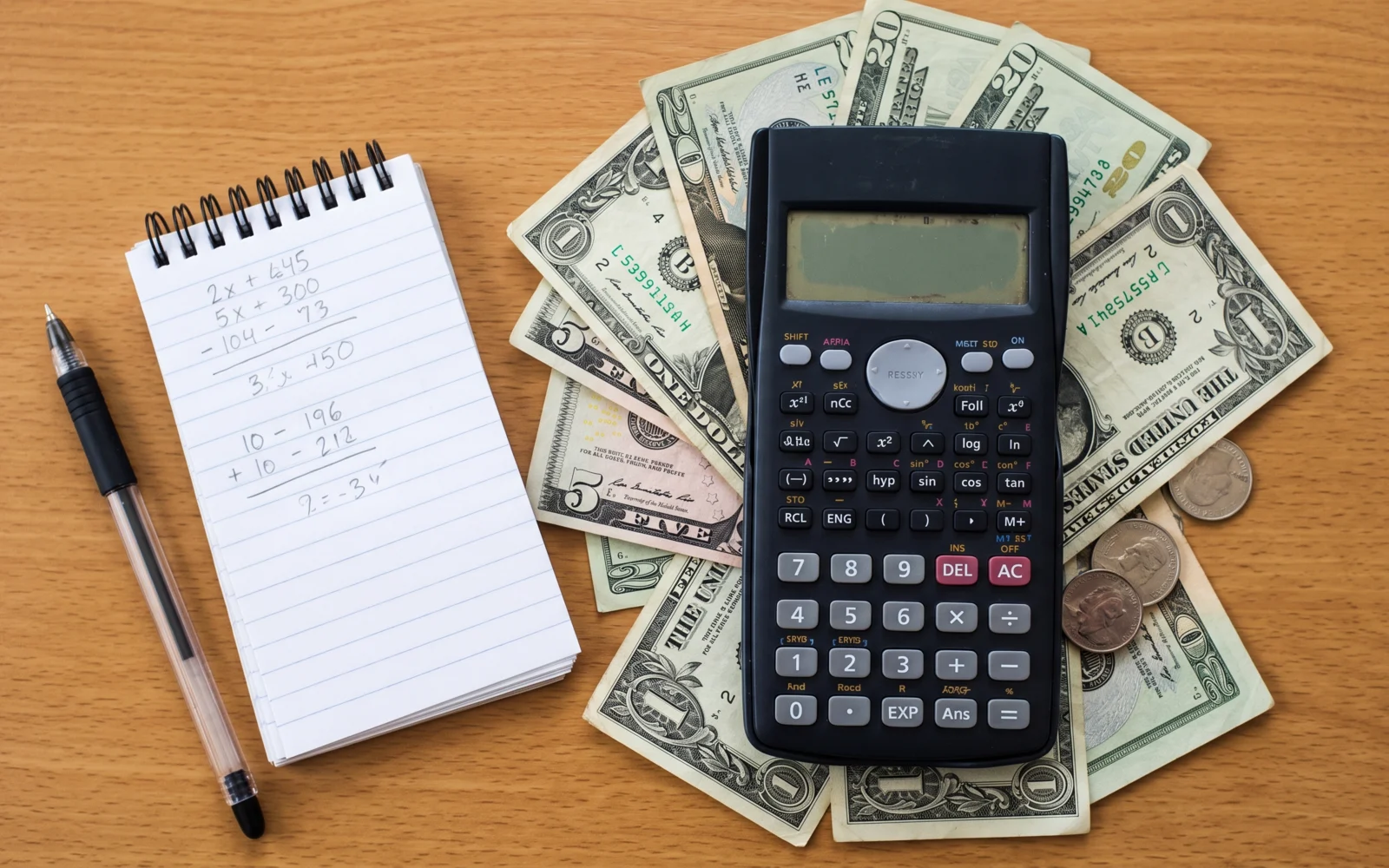 A calculator resting on cash, in a navy duotone.