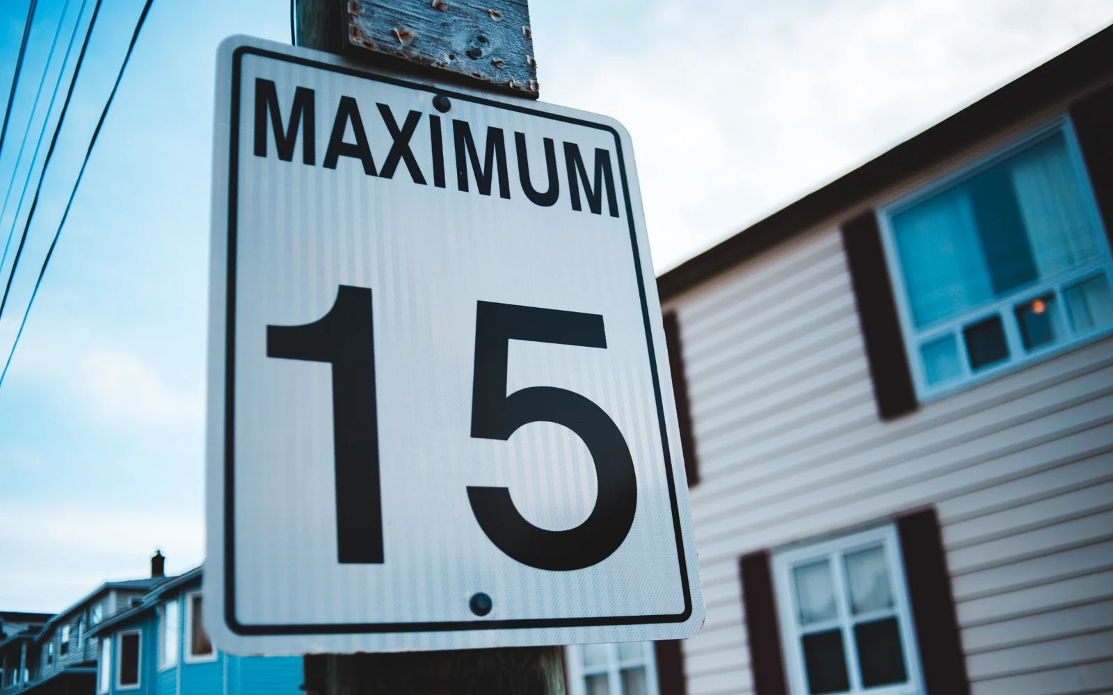 A road sign reading Maximum 15, in a navy duotone.